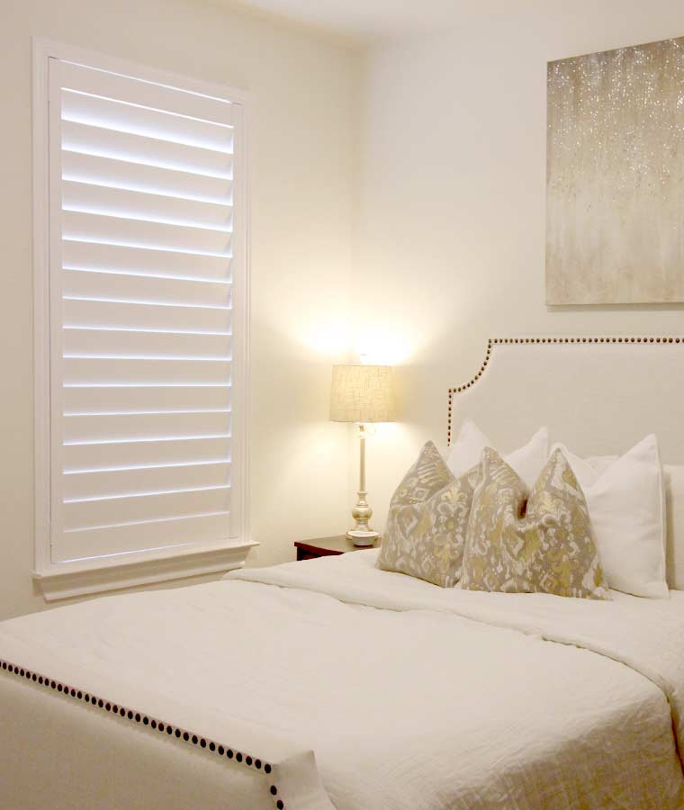 white shutters in bright bedroom